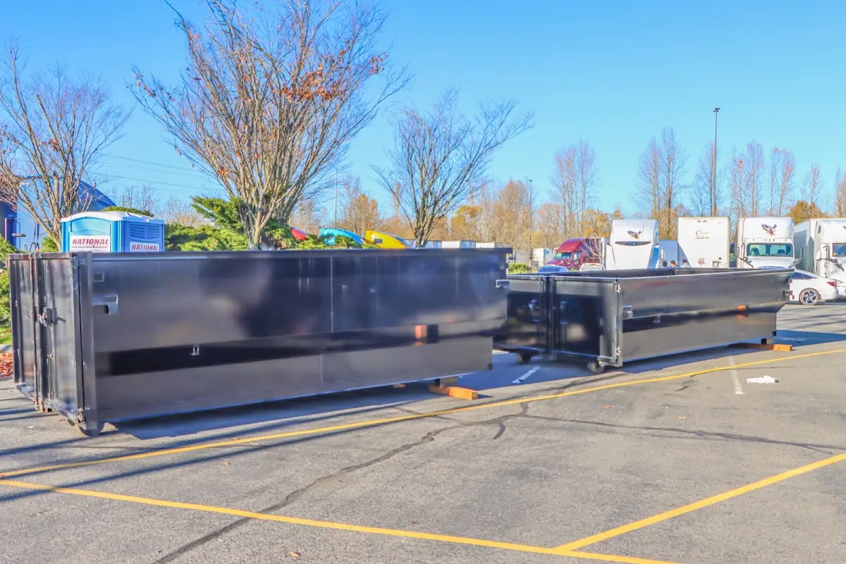 Professional dumpster rental service with roll-off container on residential driveway in Crafton
